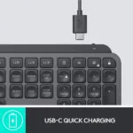 USB-C charging cable connected to Logitech MX Keys Plus keyboard, showing key layout and function keys.