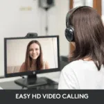 Logitech C270 Webcam mounted on a monitor showing a video call with a smiling woman.
